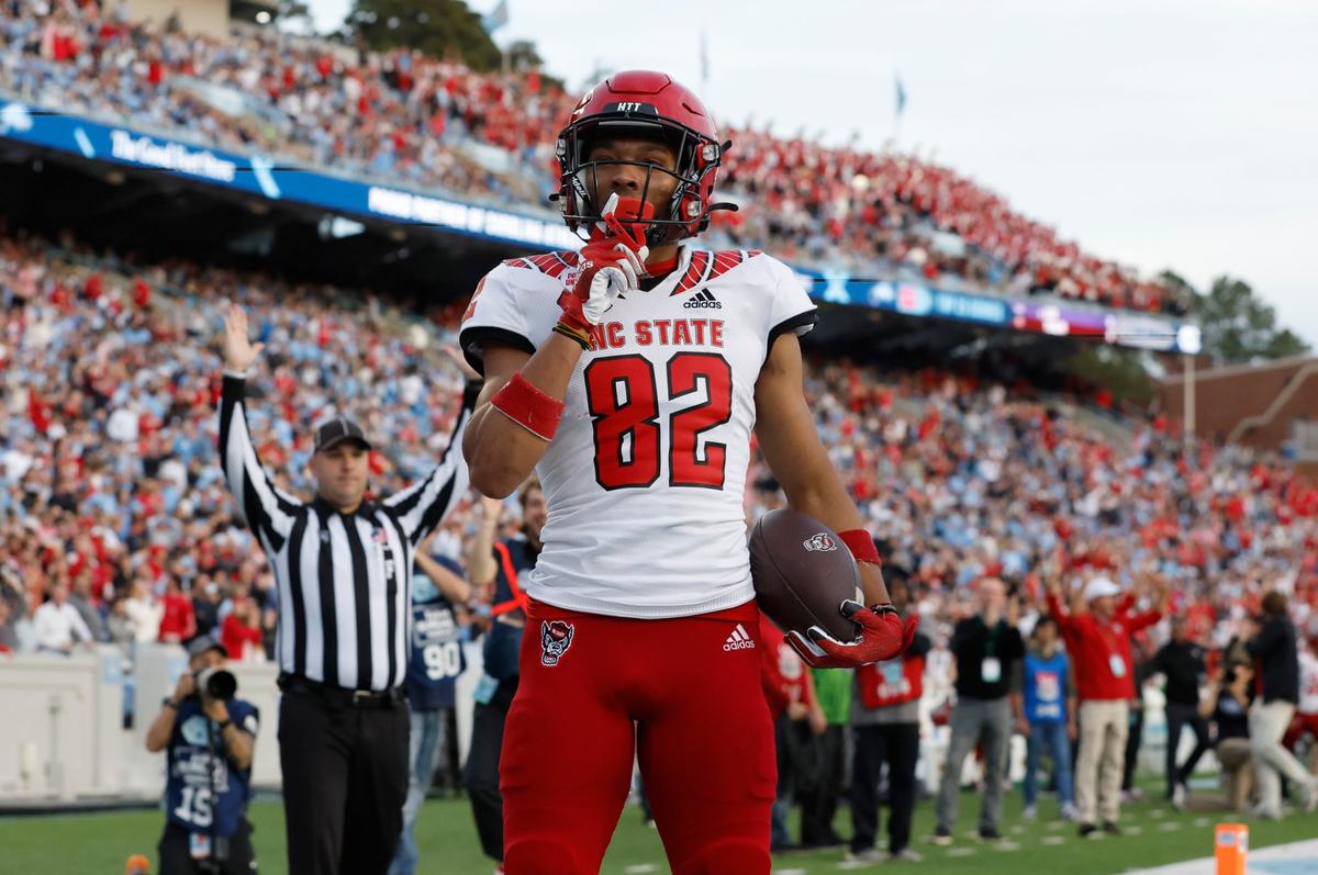 N.C. State wide receiver Terrell Timmons Jr. (82) shushes the crowd after scoring on a 28-yard touchdown reception during the first half of N.C. State’s game against UNC at Kenan Stadium in Chapel Hill, N.C., Friday, Nov. 25, 2022.