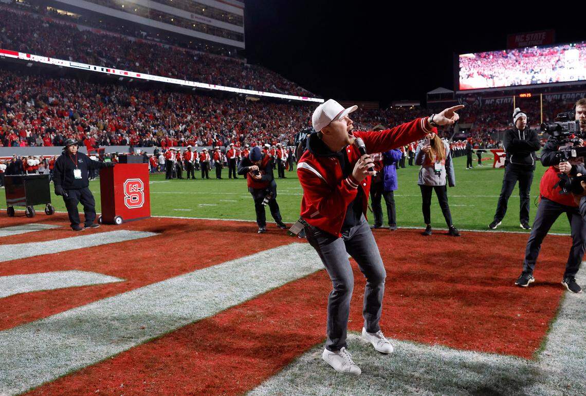 Scotty McCreery leads the crowd in a Wolfpack chant before N.C. State’s game against UNC at Carter-Finley Stadium in Raleigh, N.C., Saturday, Nov. 25, 2023.