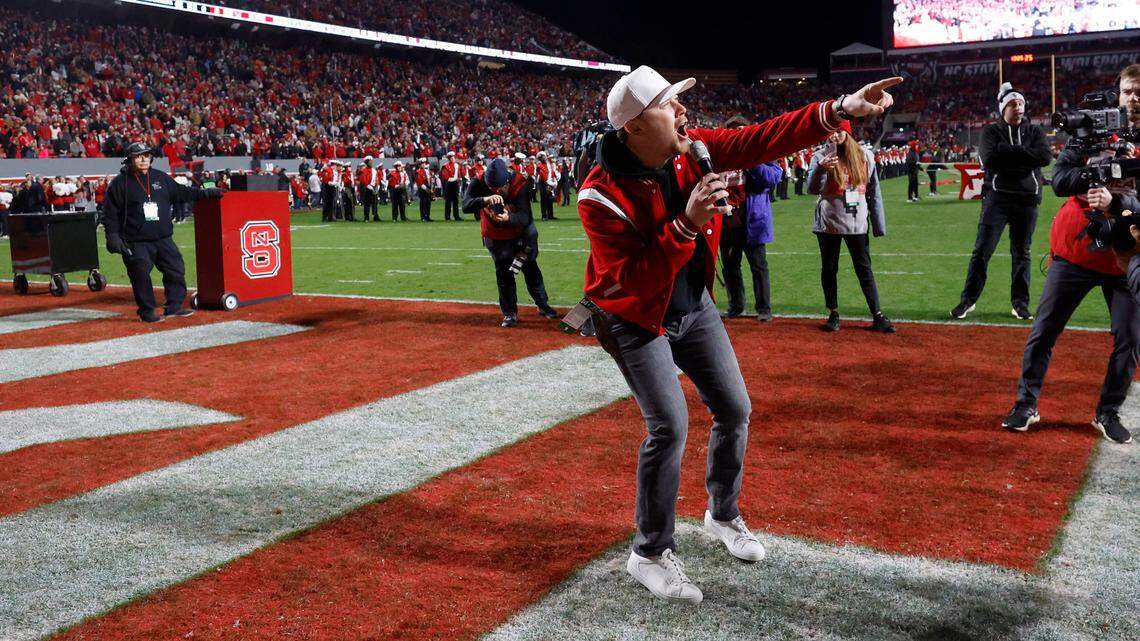 Scotty McCreery leads the crowd in a Wolfpack chant before N.C. State’s game against UNC at Carter-Finley Stadium in Raleigh, N.C., Saturday, Nov. 25, 2023.