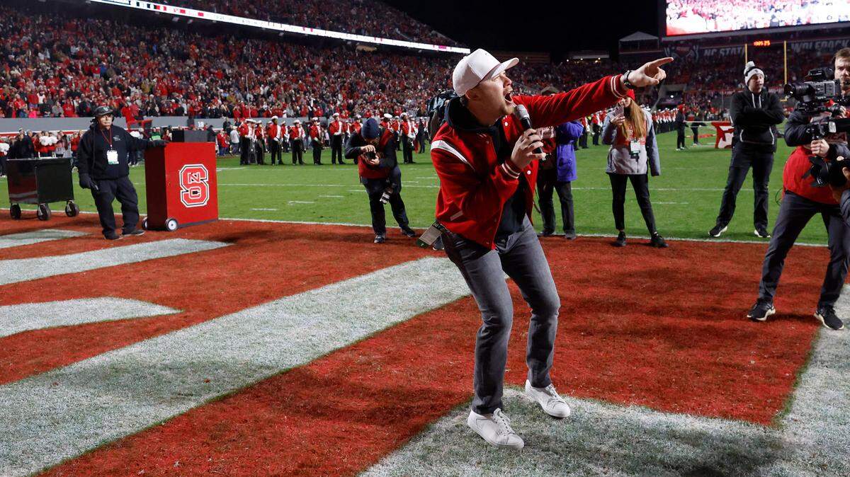 Scotty McCreery leads the crowd in a Wolfpack chant before N.C. State’s game against UNC at Carter-Finley Stadium in Raleigh, N.C., Saturday, Nov. 25, 2023.