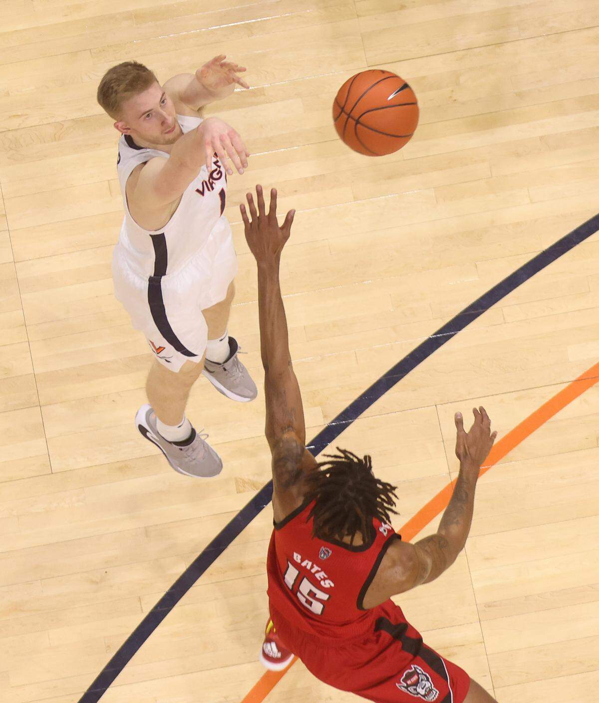 Virginia forward Sam Hauser (10) shoots a basket over North Carolina State forward Manny Bates (15).