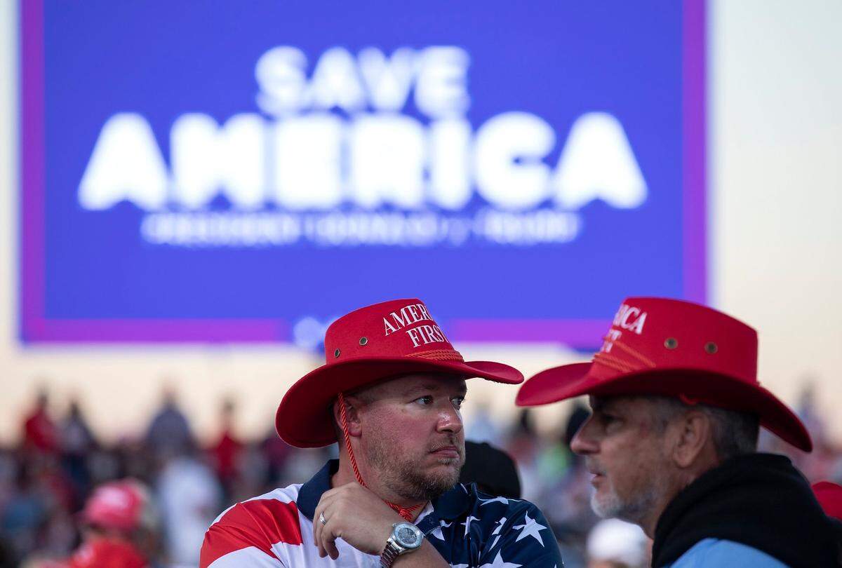 People await the arrival of former president Donald Trump during a rally at Wilmington International Airport on Friday, Sept. 23, 2022.