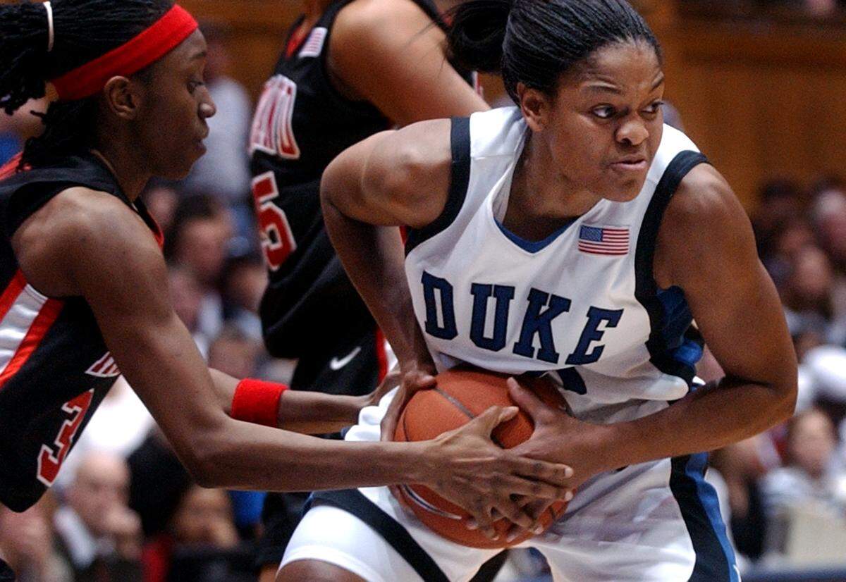 DUKE-MD9.SP.012204.JLW--Durham,NC--Duke’s Alana Beard fights past the defense of Maryland’s Anesia Smith (left) during Thursday evening’s matchup against Maryland. Duke won 78-48. staff photo by john l. white