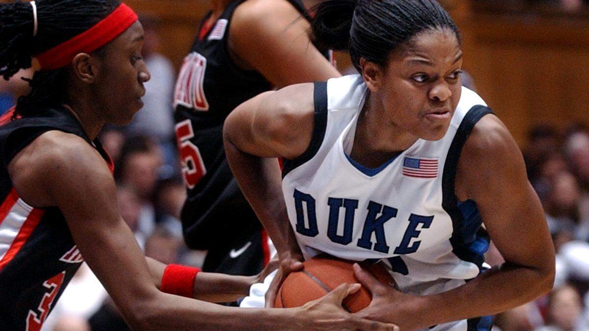 DUKE-MD9.SP.012204.JLW--Durham,NC--Duke’s Alana Beard fights past the defense of Maryland’s Anesia Smith (left) during Thursday evening’s matchup against Maryland. Duke won 78-48. staff photo by john l. white