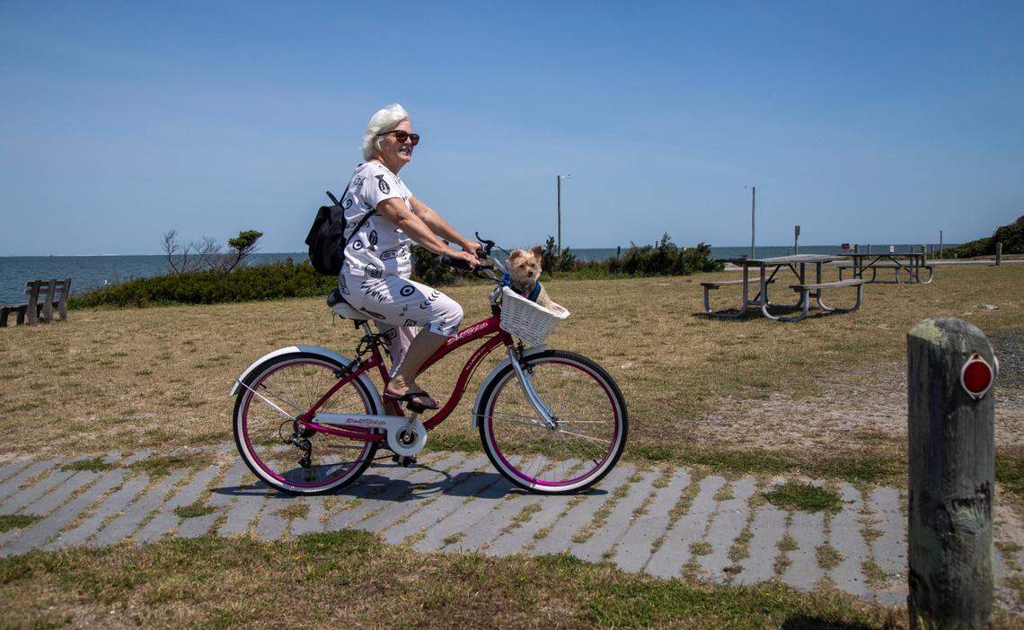 Niki Stevenson and her dog Missy tour Ocracoke by bicycle Wednesday, May 18, 2022. Bicycles and golf carts are the main modes of transportation on the island.
