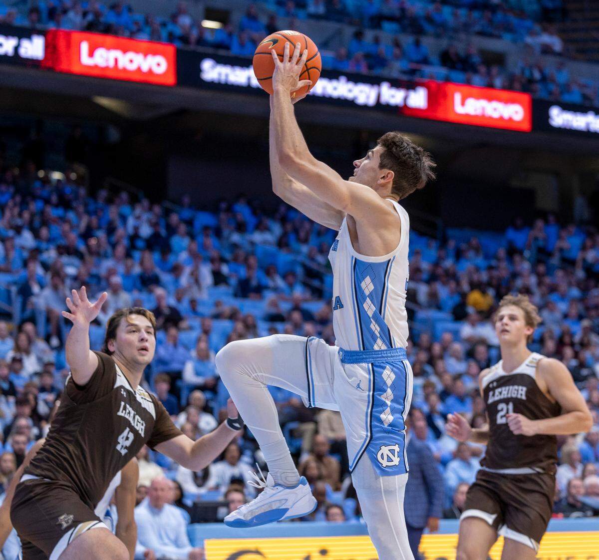 North Carolina’s Cormac Ryan (3) drives to the basket against Lehigh’s J.T. Tan (42) and Burke Chebuhar (21) in the second half on Sunday, November 12, 2023 at the Smith Center in Chapel Hill, N.C.