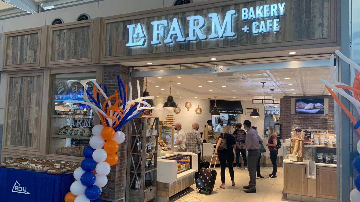 Travelers visit the newly opened La Farm Bakery and Cafe in Terminal 2 of the Raleigh-Durham International Airport Thursday, July 15, 2021.