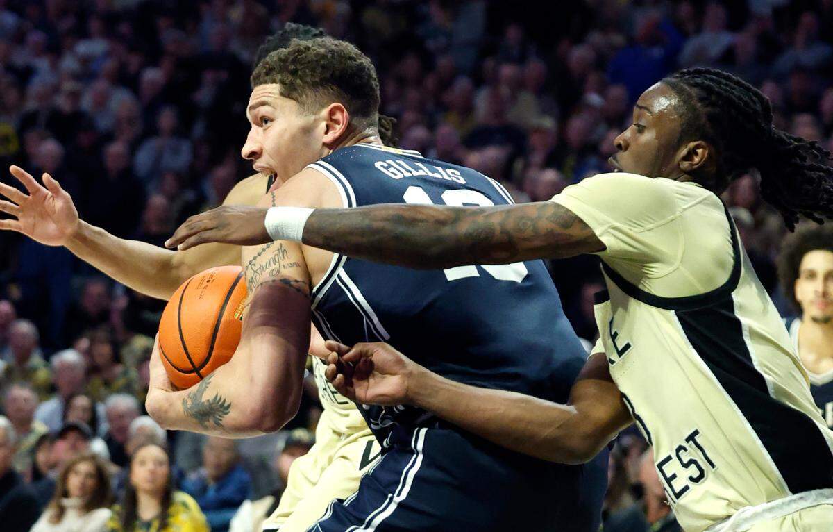 Duke’s Mason Gillis (18) gets by Wake Forest’s Ty-Laur Johnson (8) during the second half of Duke’s 63-56 victory over Wake Forest at LJVM Coliseum in Winston-Salem, N.C., Saturday, Jan. 25, 2025.