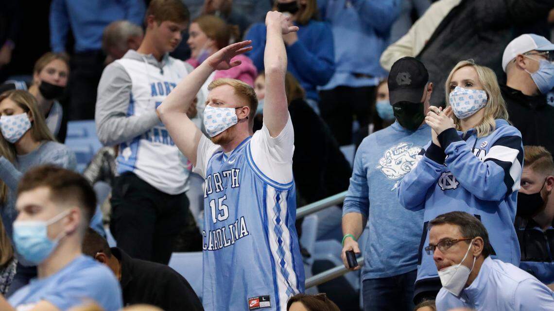 George Harmer, the “British Tar Heel” and his partner Dr. Bryony Porter cheer on the Heels after UNC defeated Boston College at the Smith Center in Chapel Hill, N.C., Wednesday, Jan. 26, 2022.