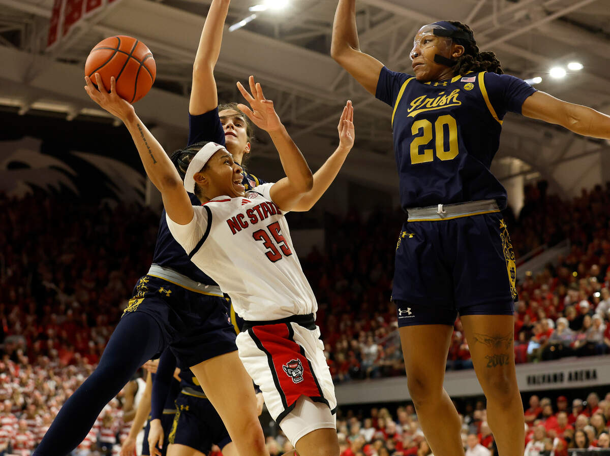 N.C. State’s Zoe Brooks drives to the basket past Notre Dame’s Sonia Citron and Liatu King during the second half of the Wolfpack’s 104-95 double overtime win on Sunday, Feb. 23, 2025, at Reynolds Coliseum in Raleigh, N.C.