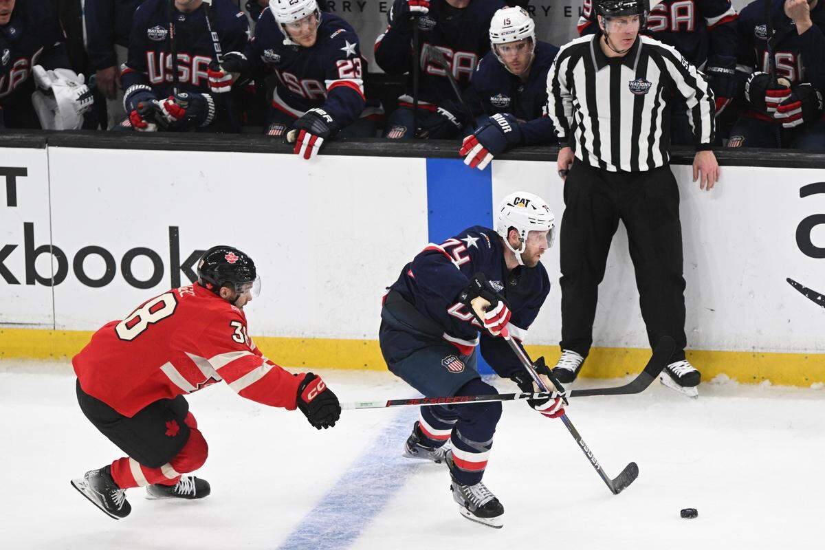 Team USA defenseman Jaccob Slavin (74) skates with the puck against Team Canada forward Brandon Hagel (38) during the third period during the 4 Nations Face-Off ice hockey championship game at TD Garden.