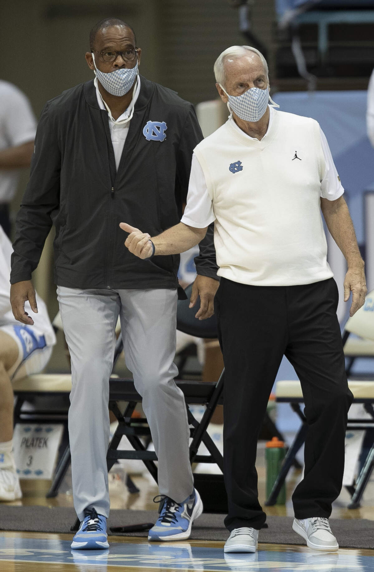North Carolina coach Roy Williams confers with assistant coach Hubert Davis in the first half against NCCU on Saturday, December 12, 2020 at the Smith Center in Chapel Hill, N.C.