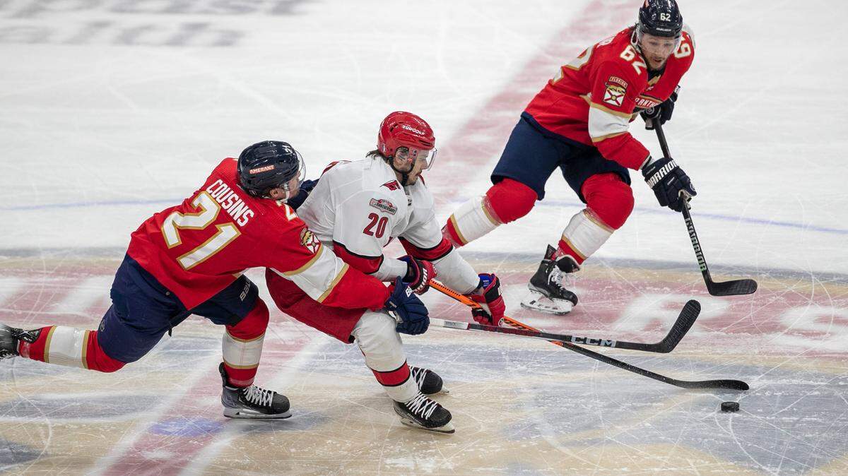 The Florida Panthers Nick Cousins (21) and Brandon Montour (62) work to slow the Carolina Hurricanes Sebastian Aho (20) in the first period of Game 3 of the Eastern Conference Finals on Monday, May 22, 2023 at FLA Live Arena in Sunrise, Fla.