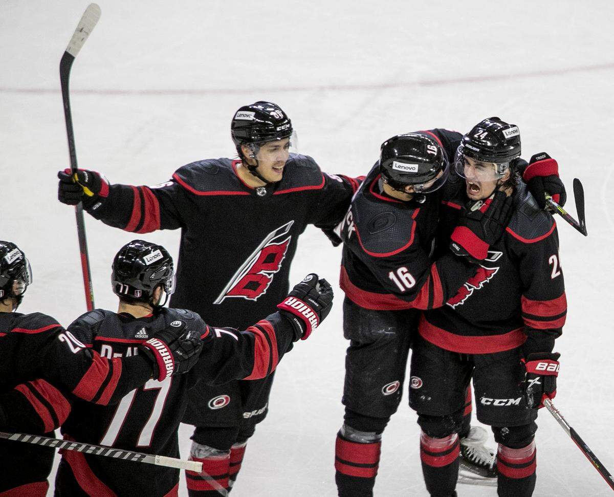 Carolina Hurricanesí Vincent Trocheck (16) embraces Seth Jarvis (24) after Jarvisí goal to give the Hurricanes a 3-0 lead in the second period on Tuesday, May 10, 2022 during game five of their Stanley Cup first round series at PNC Arena in Raleigh, N.C.