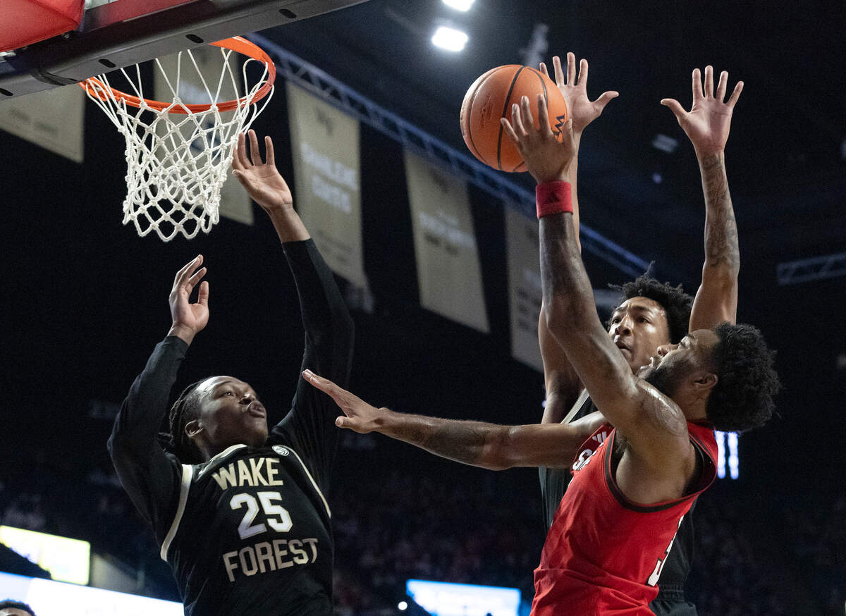 N.C. State’s Dontrez Styles drives to the basket past Wake Forest’s Tre’Von Spillers and Juke Harris during the first half of the Wolfpack’s game on Saturday, Jan. 4, 2025, at Lawrence Joel Veterans Memorial Coliseum in Winston-Salem, N.C.