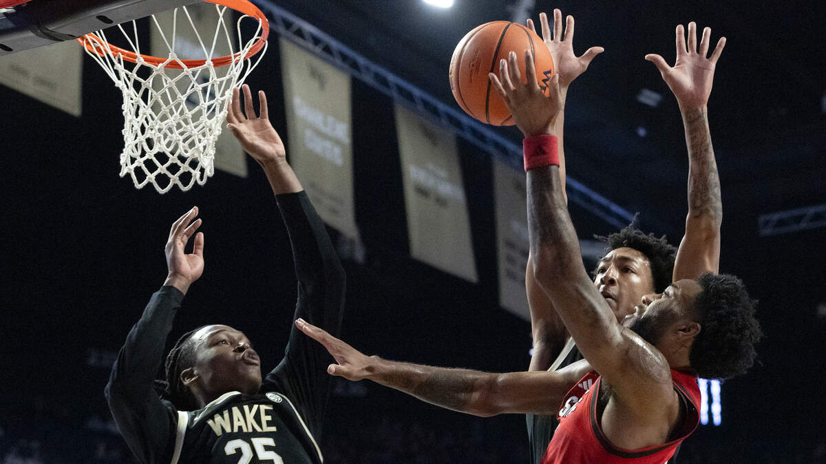 N.C. State’s Dontrez Styles drives to the basket past Wake Forest’s Tre’Von Spillers and Juke Harris during the first half of the Wolfpack’s game on Saturday, Jan. 4, 2025, at Lawrence Joel Veterans Memorial Coliseum in Winston-Salem, N.C.