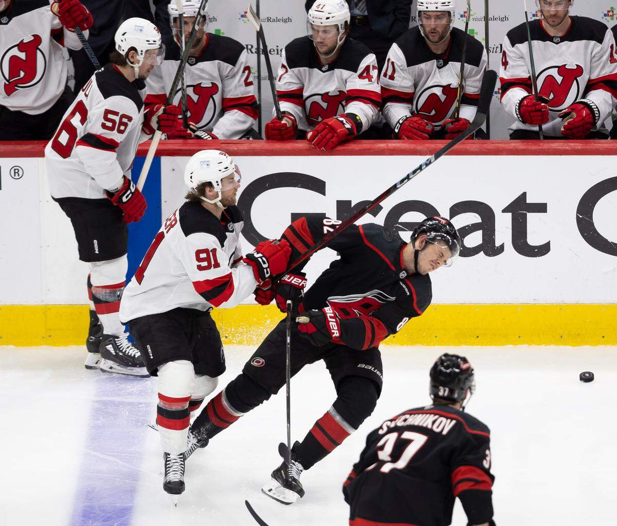 Carolina Hurricanes center Jesperi Kotkaniemi (82) reacts after taking a stick to his face from New Jersey Devils center Dawson Mercer (91) in the second overtime, to set up the game winning power play goal by Sebastian Aho on Tuesday, April 29, 2025 at Lenovo Center in Raleigh, N.C.