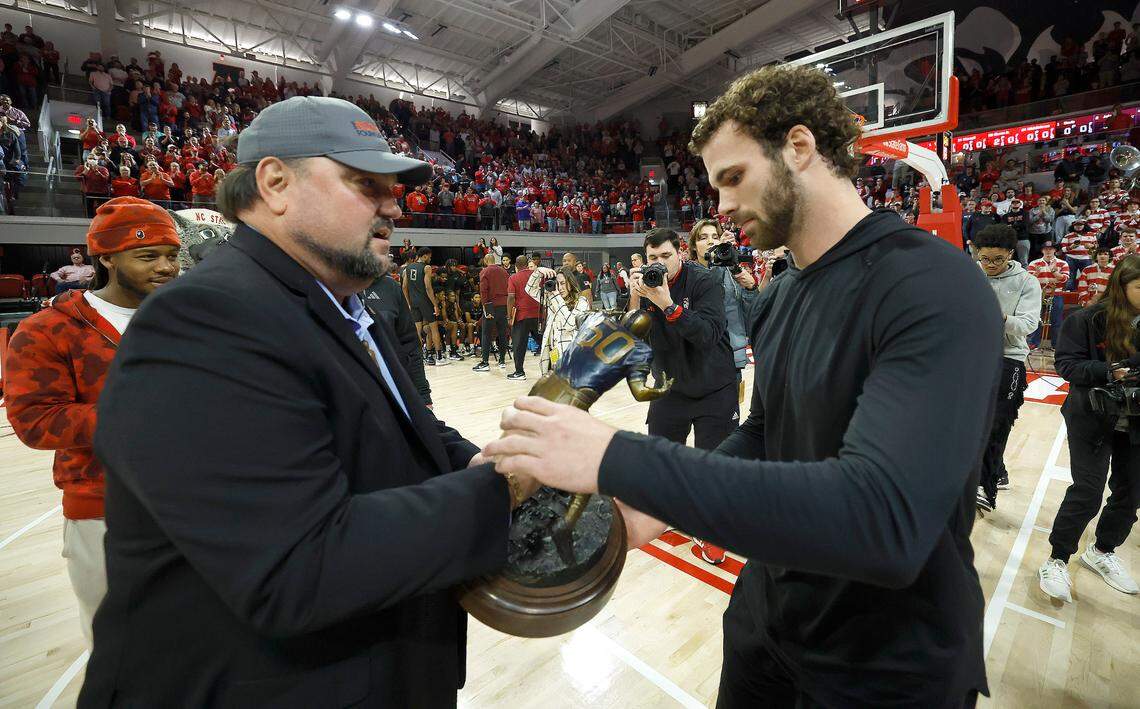 N.C. State linebacker Payton Wilson gets the Butkus Award from Matt Butkus, son of legendary NFL linebacker Dick Butkus, the award’s namesake during the Wolfpack’s basketball game against Maryland Eastern Shore at Reynolds Coliseum Wednesday, Dec. 6, 2023.