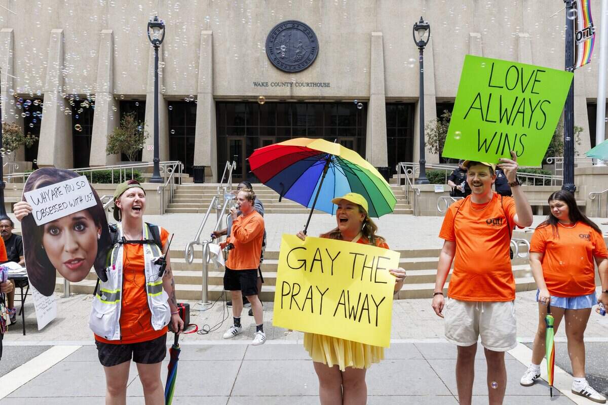 Volunteers for the Raleigh LGBT Center countered anti-gay messaging near an anti-LGBT speaker at Out! Raleigh Pride on Saturday.