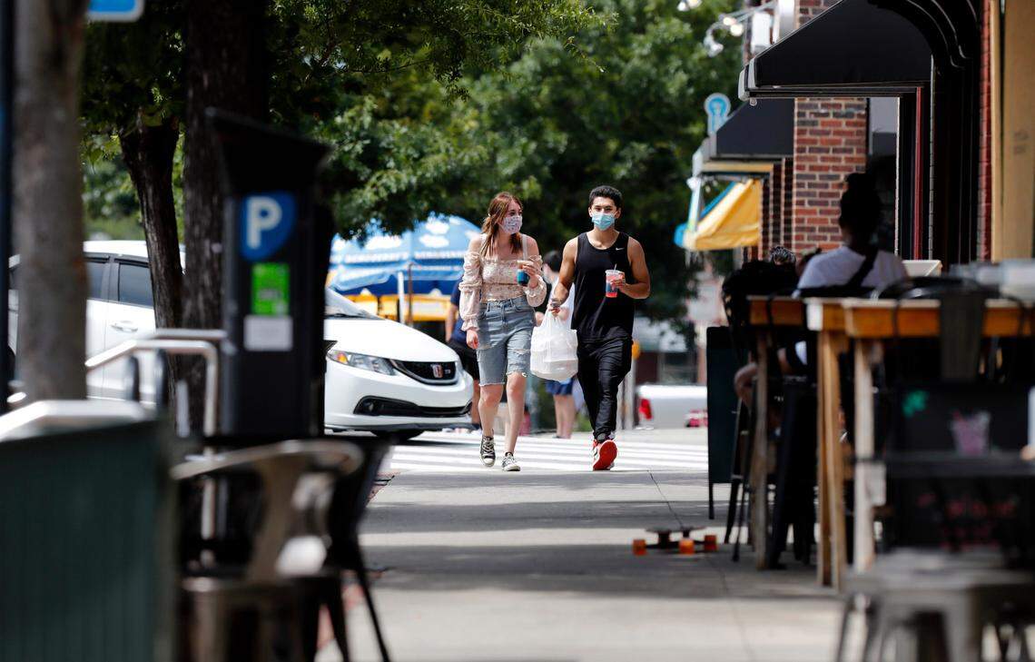 People walk down Franklin Street in Chapel Hill, N.C., Tuesday, August 18, 2020.