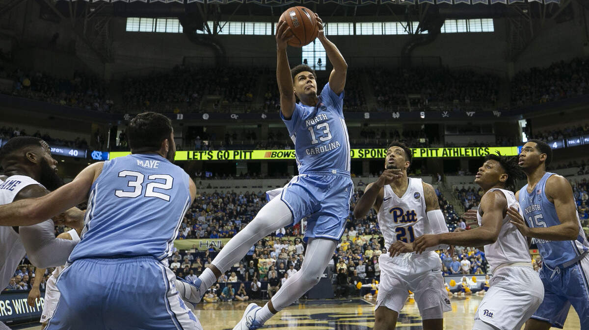 North Carolina’s Cameron Johnson (13) drives to the basket against Pitt’s Terrell Brown (21) during the first half on Saturday, January 5, 2019 at Peterson Events Center in Pittsburgh, Pa. Johnson scored 15 points in the Tar Heels’ victory.