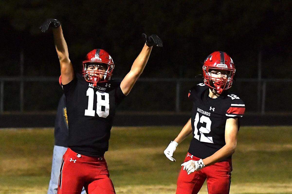 Middle Creek wide receiver M.J. Bucci (18) celebrates his touchdown against Apex Friendship with Nicolas Bocciardi (12) late in the fourth quarter. The Middle Creek Mustangs and the Apex Friendship Patriots met in a football game in Cary, N.C. on October 25, 2024.