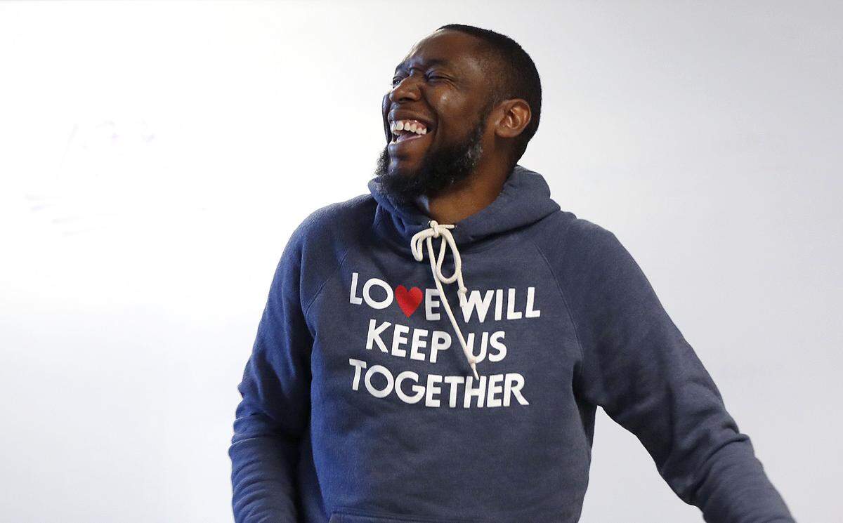Patrick Douthit, better known as 9th Wonder, laughs as he talks with students while teaching the History of Hip Hop at North Carolina Central University in Durham, N.C., Thursday, October 24, 2019.