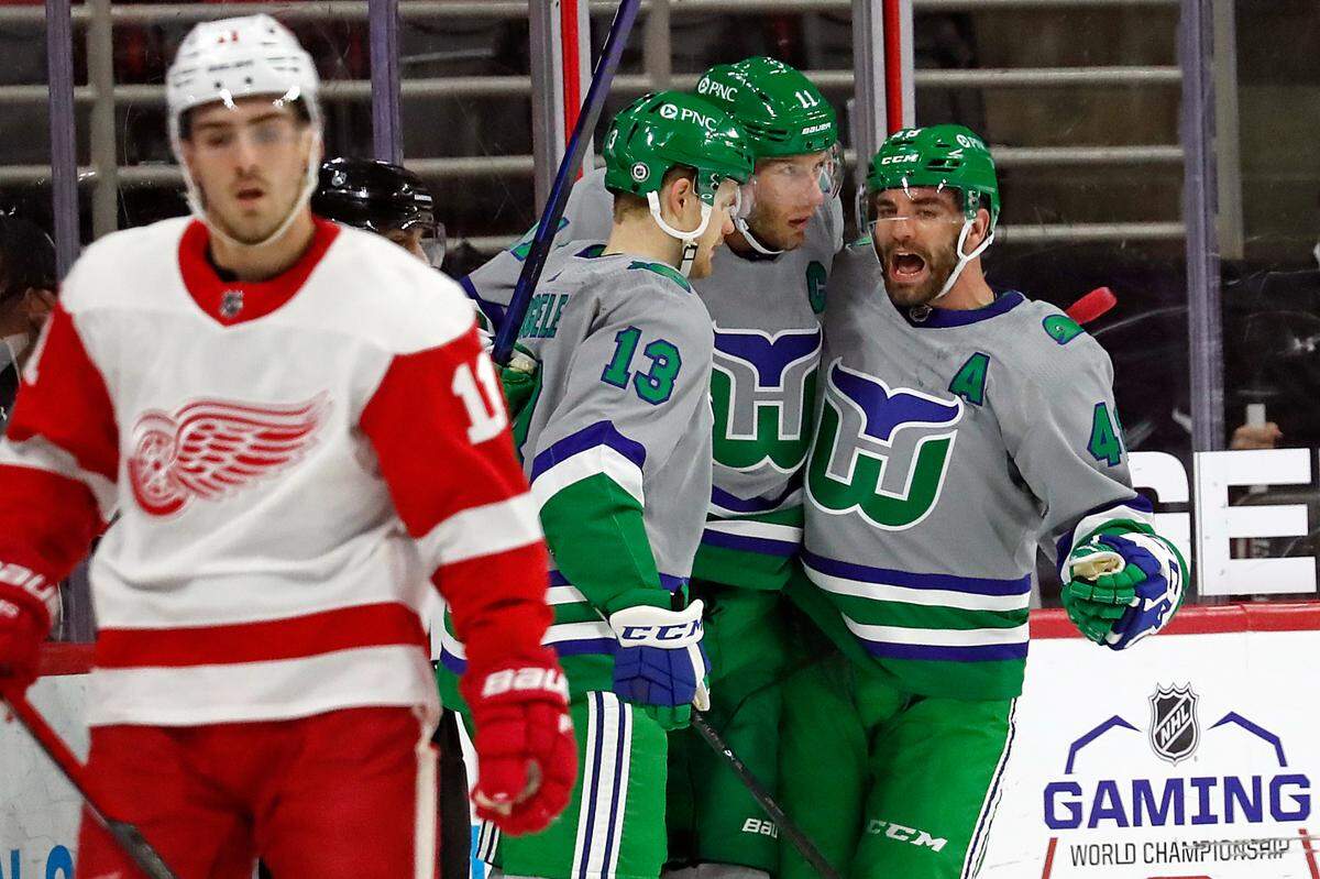 Carolina Hurricanes’ Jordan Staal (11), center, is congratulated on his goal by teammates Warren Foegele (13) and Jordan Martinook (48) during the first period of an NHL hockey game against the Detroit Red Wings in Raleigh, N.C., Saturday, April 10, 2021. (AP Photo/Karl B DeBlaker)