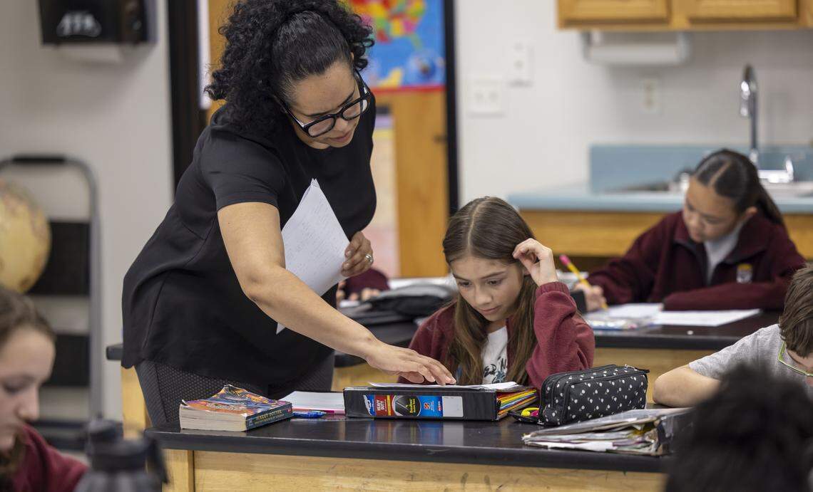 Nadilynn Morales, a sixth-grade science teacher at St. Catherine of Siena Catholic School, works with Violeta Zapata-Echeverri on Thursday, Feb. 12, 2026, in Wake Forest. 