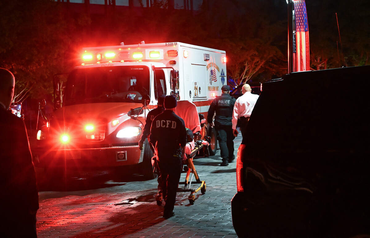 Emergency responders return to their truck pushing a gurney carrying equipment outside the Washington Hilton after shots were heard during the White House Correspondents' Dinner in Washington, D.C., on April 25, 2026. 
