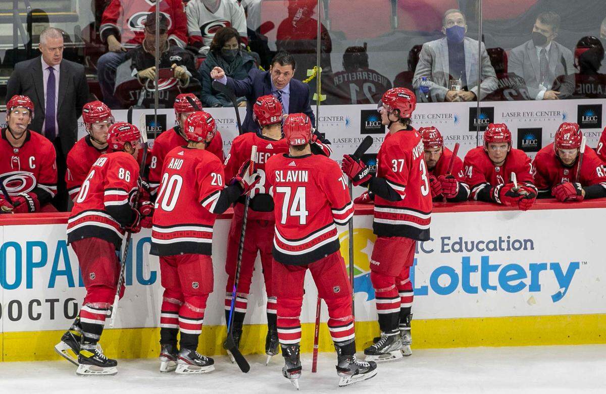 Carolina Hurricanes coach Rod Brind’Amour huddles with his players during a time-out in the third period against the Ottawa Senators on Thursday, December 2, 2021 at PNC Arena in Raleigh, N.C.