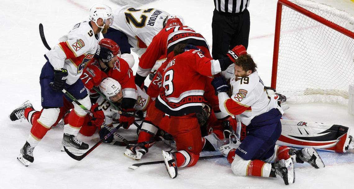 Players pile in front of the net after Carolina goaltender Antti Raanta (32) dove on the puck during the second period of game two between the Hurricanes and Panthers in the Eastern Conference Finals at PNC Arena in Raleigh, N.C., Saturday, May 20, 2023.