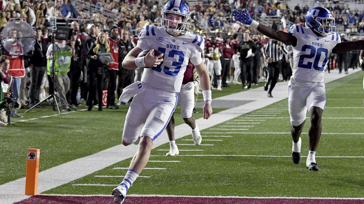 Duke quarterback Riley Leonard (13) runs into the end zone to score during the first half of an NCAA college football game against Boston College, Friday, Nov. 4, 2022 in Boston. (AP Photo/Mark Stockwell)