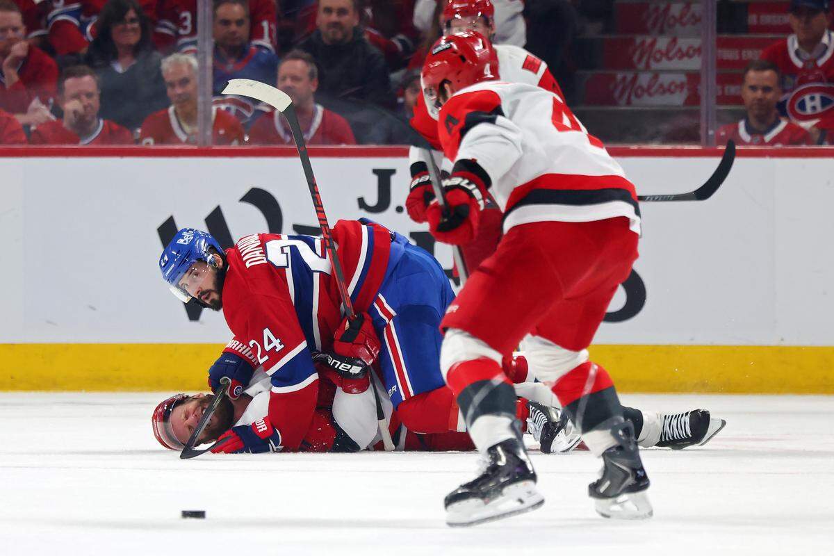 Phillip Danault #24 of the Montreal Canadiens is called for a cross-checking penalty on Jordan Staal #11 of the Carolina Hurricanes during the second period in Game Four of the Eastern Conference Final of the 2026 Stanley Cup Playoffs at Bell Centre on May 27, 2026 in Montreal, Quebec, Canada. 