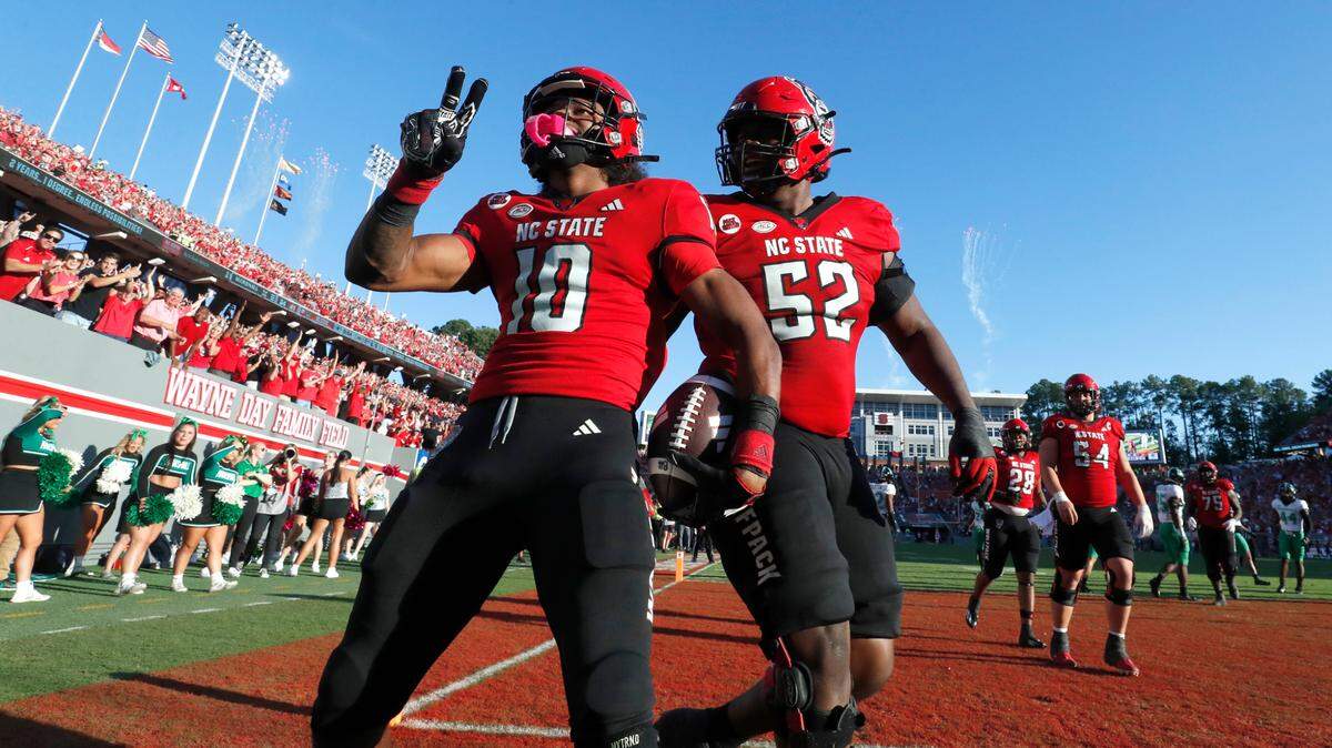 N.C. State wide receiver KC Concepcion (10) celebrates with lineman Timothy McKay (52) after scoring on a 8-yard touchdown reception during the second half of N.C. State’s 48-41 victory over Marshall at Carter-Finley Stadium in Raleigh, N.C., Saturday, Oct. 7, 2023.