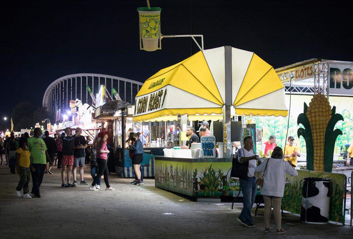 Patrons of the North Carolina State Fair enjoy fair food in Raleigh, N.C. on opening night, Thursday, Oct. 14, 2021.