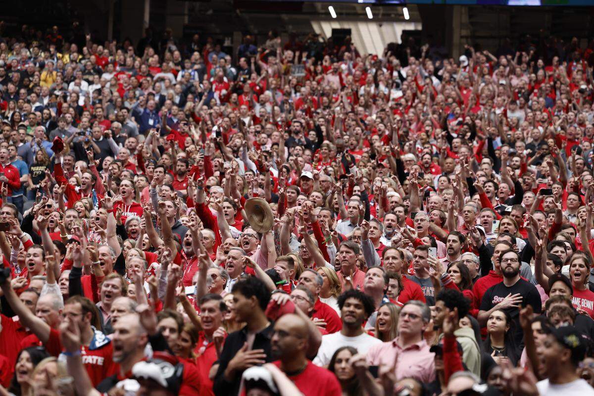 NC State fans cheer on the Wolfpack during their Final Four game against Purdue, Saturday, April 6, 2024.