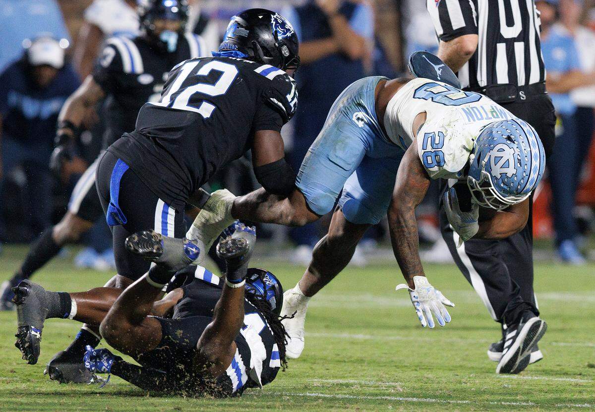 Duke’s Tre Freeman and Cameron Bergeron tackle North Carolina’s Omarion Hampton during the second half of the Blue Devils’ 21-20 win on Saturday, Sept. 28, 2024, at Wallace Wade Stadium in Durham, N.C.