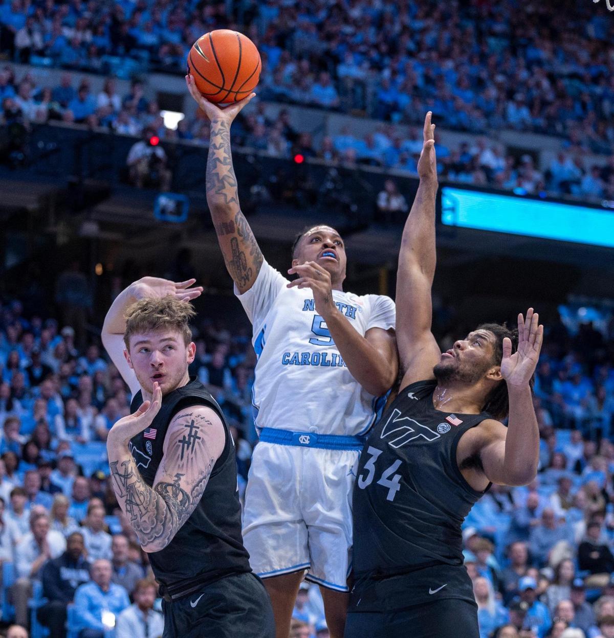 North Carolina’s Armando Bacot (5) puts up a shot over Virginia Tech’s Mylyjael Poteat (34) and Tyler Nickel (23) during the first half on Saturday, February 17, 2023 at the Smith Center in Chapel Hill, N.C.