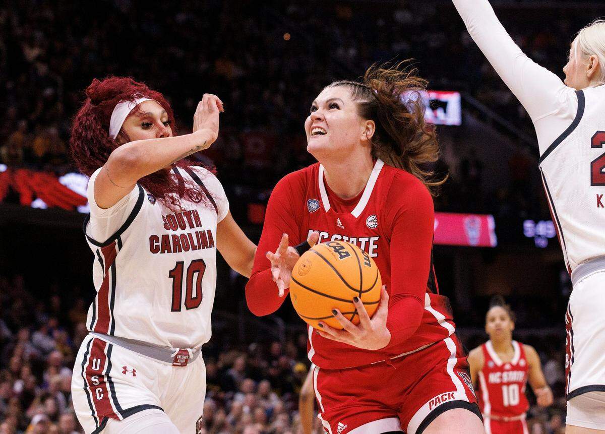 N.C. State’s River Baldwin drives to the basket past South Carolina’s Kamilla Cardoso during the first half of the Wolfpack’s Final Four matchup at Rocket Mortgage FieldHouse on Friday, April 5, 2024, in Cleveland, Ohio.