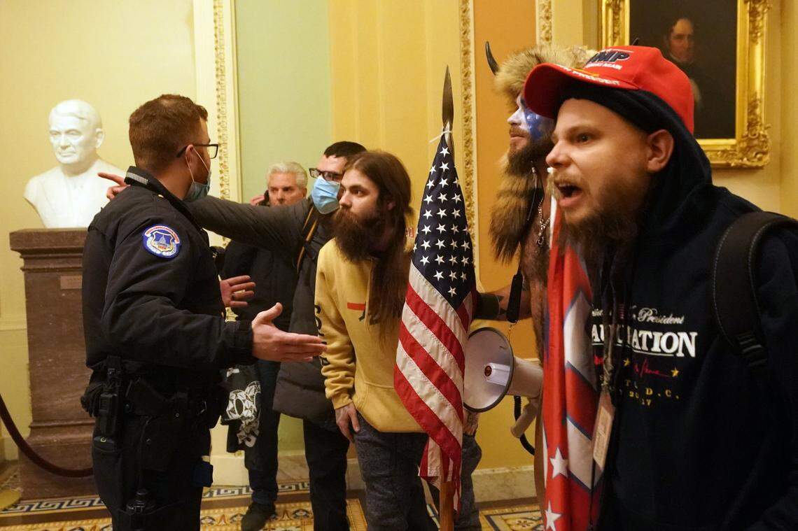 A Capitol Hill police officer confronts people protesting the presidential election results inside the Capitol in Washington on Wednesday, Jan. 6, 2020. The Capitol building was placed on lockdown, with senators and members of the House locked inside their chambers, as Congress began debating President-elect Joe Biden’s victory. President Trump addressed supporters near the White House before protesters marched to Capitol Hill. (Erin Schaff/The New York Times)