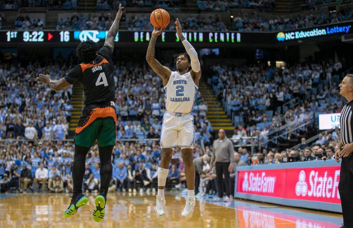 North Carolina’s Caleb Love (2) puts up a shot against Miami’s Bensely Joseph (4) in the first half on Monday, February 13, 2023 at the Smith Center in Chapel