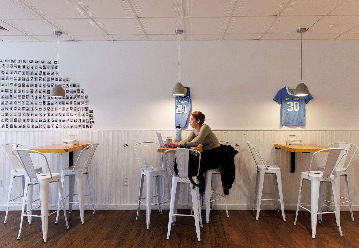 A person works on a laptop inside of The Purple Bowl on Franklin Street on Thursday, Jan. 11, 2024, in Chapel Hill, N.C.