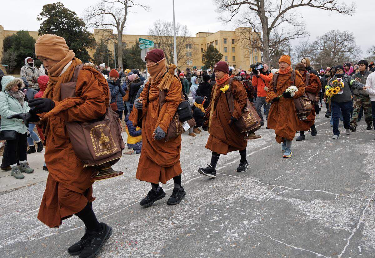 A procession of Buddhist monks walk through Dorothea Dix Park as a part of the Walk for Peace on Saturday, Jan. 24, 2026, in Raleigh, N.C.