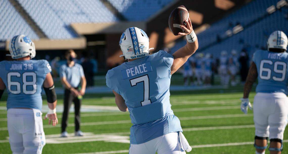 North Carolina quarterback Sam Howell (7) has replaced his last name with ‘Peace” on the back of his game jersey as he warms up for the Tar Heels’ game against Notre Dame on Saturday, November 27, 2020 at Kenan Stadium in Chapel Hill, N.C. Several players has done the same, choosing other messages for this particular game.