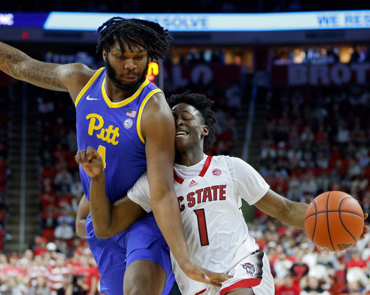 N.C. State’s Jarkel Joiner drives past Pitt’s John Hugley IV during the second half of a men’s basketball game at PNC Arena on Friday, Dec. 2, 2022, in Raleigh, N.C.