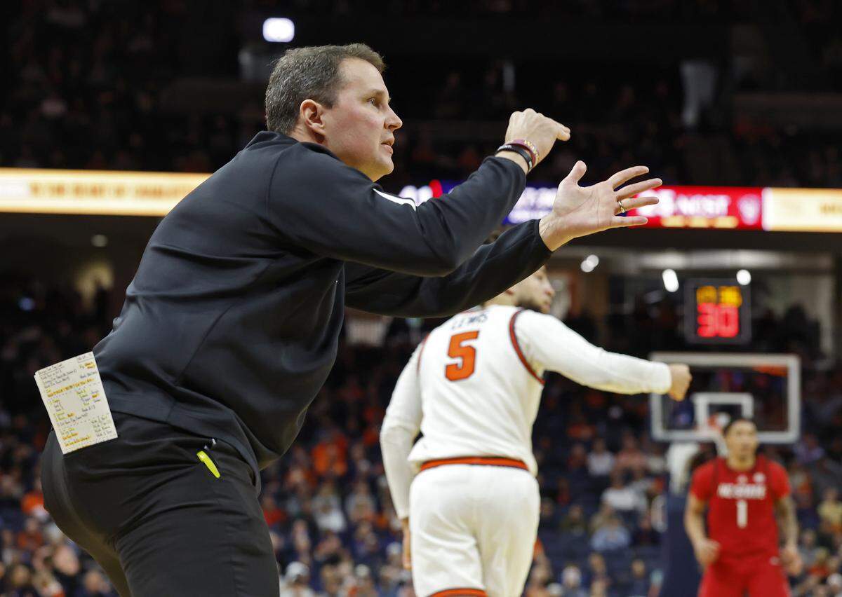 N.C. State head coach Will Wade attempts to call a timeout during the second half of the Wolfpack’s 90-61 loss to Virginia on Thursday, Feb. 24, 2026, at John Paul Jones Arena in Charlottesville, Va. 