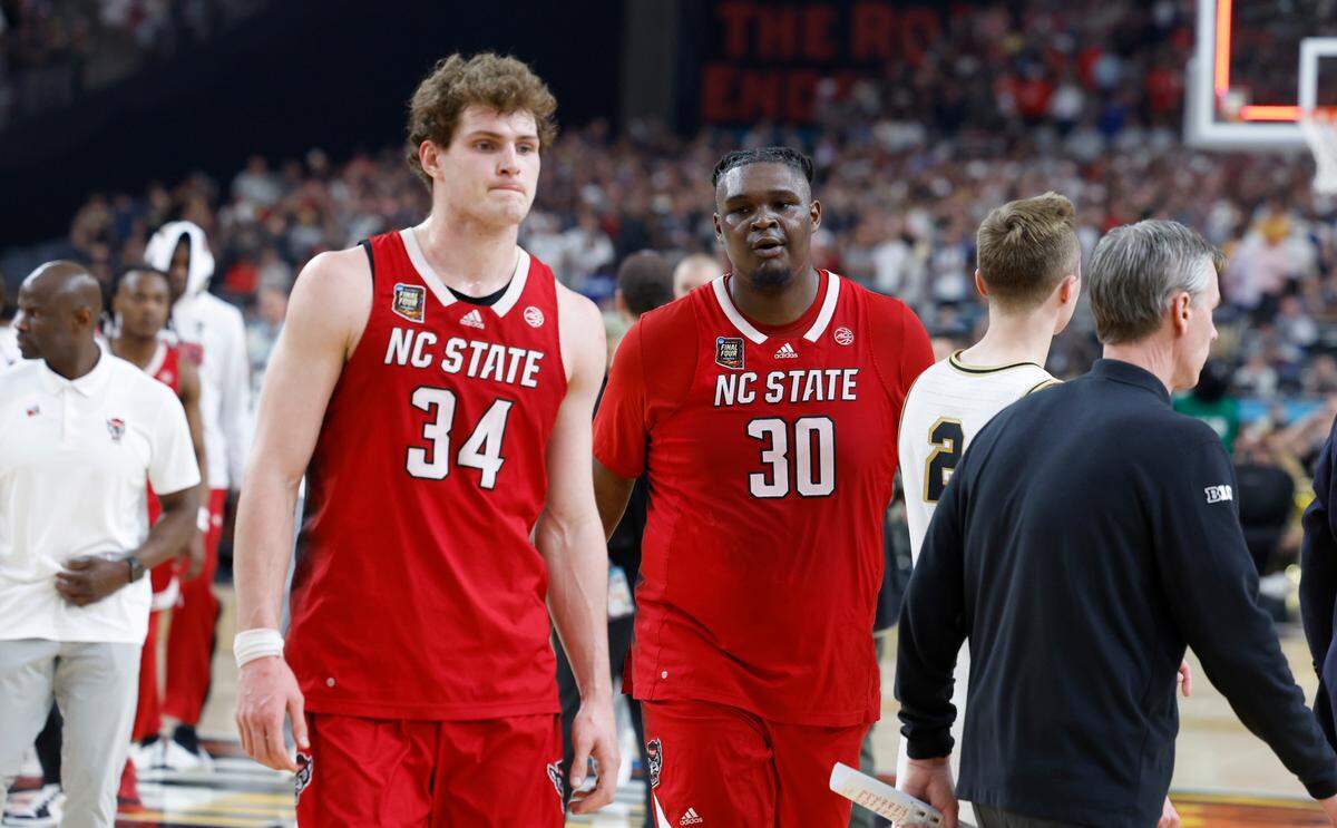 N.C. State’s Ben Middlebrooks (34) and DJ Burns Jr. (30) walk off the court after Purdue’s 63-50 victory over N.C. State in the NCAA Tournament national semifinals at State Farm Stadium in Glendale, Ariz., Saturday, April 6, 2024.
