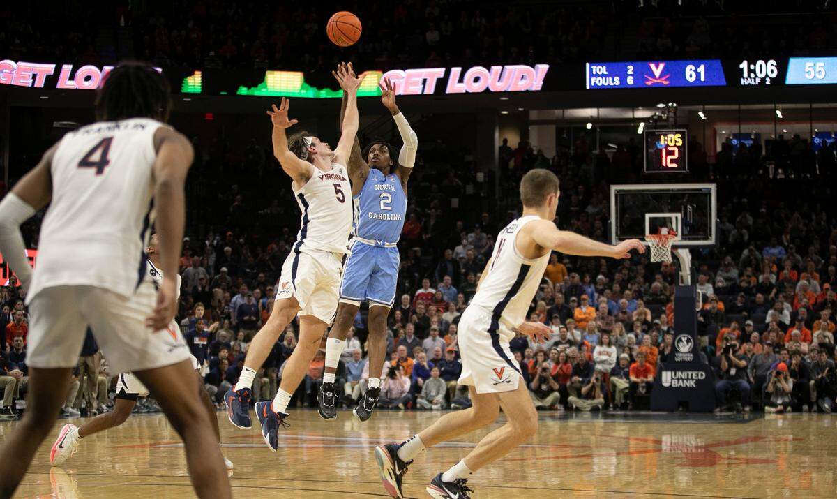 North Carolina’s Caleb Love (2) scores a three point basket with 1:08 to play in the game pulling the Tar Heels to within three points. It would be last basket the Tar Heels scored as Virginia rolled to a 65-58 victory on Tuesday, January 10, 2023 at John Paul Jones Arena in Charlottesville, Va.