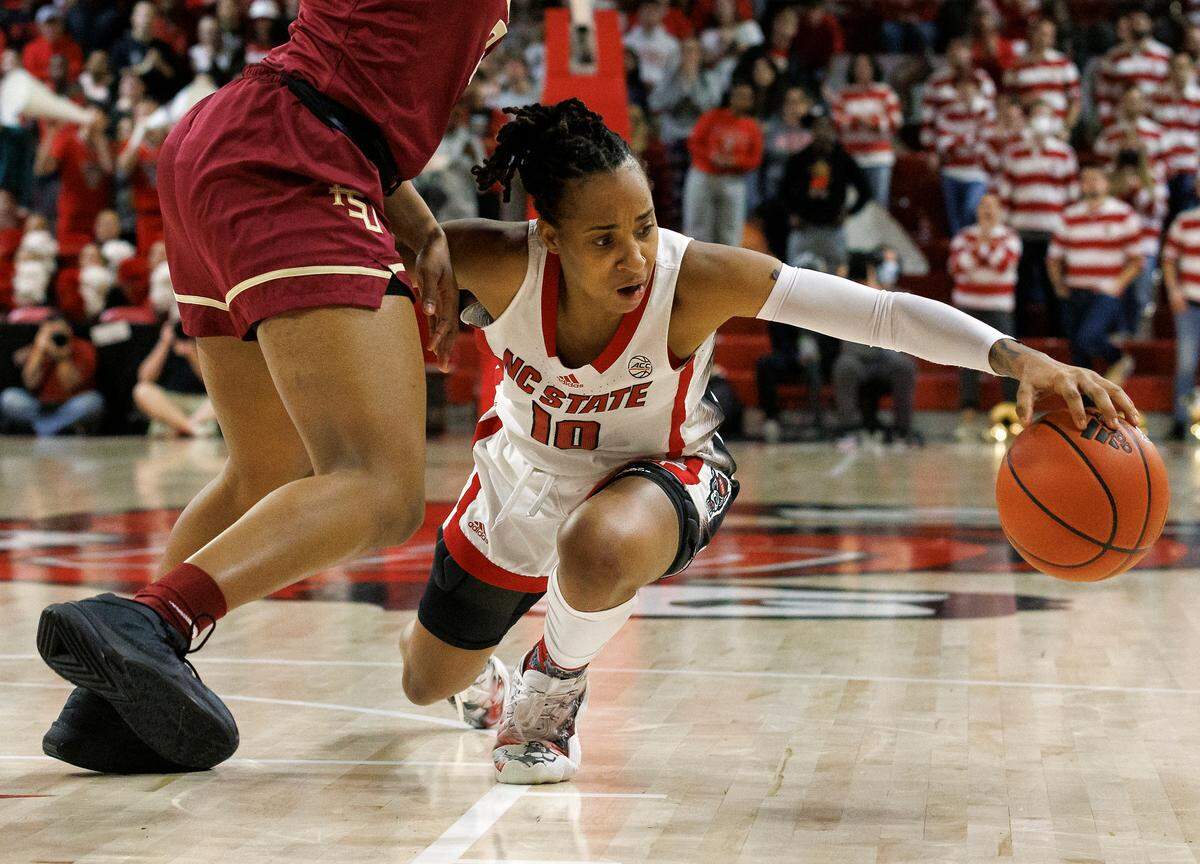 N.C. State’s Aziaha James handles the ball under pressure from Florida State’s Alexis Tucker during overtime of the Wolfpack’s 88-80 win on Thursday, Jan. 4, 2023, at Reynolds Coliseum in Raleigh, N.C.